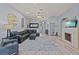 Spacious living room featuring a fireplace, ceiling fan, and modern decor at 318 39Th Ne St, Bradenton, FL 34208
