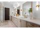 Bright bathroom featuring an expansive vanity, marble floors, and modern fixtures at 3212 Signet Ct, Sarasota, FL 34240