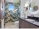 Modern bathroom features a uniquely patterned shower and sleek, contemporary fixtures at 3212 Signet Ct, Sarasota, FL 34240
