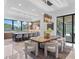 Bright dining area featuring stylish modern chandelier, marble flooring and outdoor patio access at 3212 Signet Ct, Sarasota, FL 34240