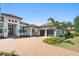 Beautiful home with a three-car garage, elegant entryway, landscaped yard, and a paver driveway at 3212 Signet Ct, Sarasota, FL 34240