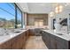 Kitchen featuring stainless appliances, custom cabinets, marble backsplash, and island with bar seating at 3212 Signet Ct, Sarasota, FL 34240