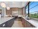 Well-lit kitchen with a large island, stainless steel appliances and picturesque outdoor view at 3212 Signet Ct, Sarasota, FL 34240