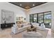 Spacious living room features a modern sectional sofa, large windows, and an open floor plan leading to the kitchen at 3212 Signet Ct, Sarasota, FL 34240
