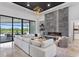 Bright living room features a modern fireplace, floor-to-ceiling windows with views, and stylish decor at 3212 Signet Ct, Sarasota, FL 34240