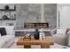 Modern living room showcases a linear fireplace, a stylish coffee table, and open shelving at 3212 Signet Ct, Sarasota, FL 34240