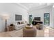 Spacious living room with contemporary decor and light walls, complemented by stylish furniture and art at 3212 Signet Ct, Sarasota, FL 34240