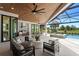 Expansive outdoor patio features a summer kitchen, comfortable seating, dining area, and pool with a view of the golf course at 3212 Signet Ct, Sarasota, FL 34240