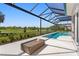 The backyard patio has a fire table and a view of the golf course at 3212 Signet Ct, Sarasota, FL 34240