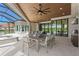 Relaxing outdoor patio features a dining area with seating, a summer kitchen, and a spa at 3212 Signet Ct, Sarasota, FL 34240