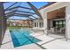 The backyard features a screened pool area, summer kitchen and outdoor dining space at 3212 Signet Ct, Sarasota, FL 34240