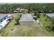 Aerial view of the house, large yard, storage shed, and patio with white privacy fence at 3411 15Th E St, Ellenton, FL 34222