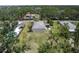 Aerial view featuring the house, a large, grassy yard, storage shed and covered patio area at 3411 15Th E St, Ellenton, FL 34222