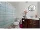 Cozy bathroom featuring a vanity with a modern sink, toilet, and shower with striped curtain at 3411 15Th E St, Ellenton, FL 34222