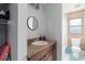 Well-lit bathroom featuring a single sink vanity and shower with wood paneling at 3411 15Th E St, Ellenton, FL 34222