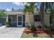 Back exterior view showcasing a screened patio and tropical landscaping for a relaxed outdoor living at 3411 15Th E St, Ellenton, FL 34222