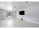 Spacious living room with tiled floor, modern ceiling fan and natural light, ideal for a comfortable living space at 3411 15Th E St, Ellenton, FL 34222