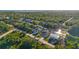 Scenic aerial view of waterfront homes with lush landscaping and private docks on a sunny day at 3415 Knox Ter, Port Charlotte, FL 33948