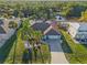 Aerial view of a charming single Gathering home featuring lush tropical landscaping, an attached two car garage and screened in patio at 3415 Knox Ter, Port Charlotte, FL 33948