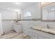 Spa-like bathroom with dual vanities, granite countertops, and elegant decorative tile at 3415 Knox Ter, Port Charlotte, FL 33948