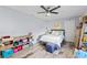Bright bedroom with ceiling fan, closet, hardwood floors, and stylish decor at 3415 Knox Ter, Port Charlotte, FL 33948