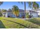 Beautiful single Gathering home with manicured lawn, lush tropical landscaping and an attached two car garage at 3415 Knox Ter, Port Charlotte, FL 33948