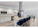 Spacious kitchen with white cabinets, stainless steel appliances, and an island with counter seating at 3415 Knox Ter, Port Charlotte, FL 33948