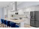 Renovated kitchen featuring white cabinets, stainless steel appliances, and a large island with seating at 3415 Knox Ter, Port Charlotte, FL 33948