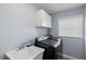 A modern laundry room with sleek appliances, built in cabinets, and convenient sink at 3415 Knox Ter, Port Charlotte, FL 33948