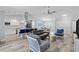 Spacious living room with vaulted ceilings, wood tile flooring, and open floor plan to the kitchen and dining area at 3415 Knox Ter, Port Charlotte, FL 33948