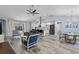 Spacious living room with vaulted ceilings, wood tile flooring, and open floor plan to the kitchen at 3415 Knox Ter, Port Charlotte, FL 33948