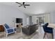 Spacious living room with vaulted ceilings, wood tile flooring and a sliding glass door leading to a screened in patio at 3415 Knox Ter, Port Charlotte, FL 33948