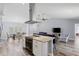 Open living space with a modern kitchen island, dining area, and comfortable seating at 3415 Knox Ter, Port Charlotte, FL 33948