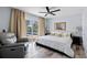 Relaxing main bedroom featuring light hardwood floors, recliner, and a private sliding door at 3415 Knox Ter, Port Charlotte, FL 33948