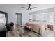 Light and airy primary bedroom featuring a ceiling fan, wood floors, and bay window at 3415 Knox Ter, Port Charlotte, FL 33948