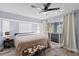 Main bedroom with hardwood floors, bay window, ceiling fan, and patio access at 3415 Knox Ter, Port Charlotte, FL 33948