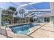Screened-in pool with waterfront views, deck area, and tropical landscaping at 3415 Knox Ter, Port Charlotte, FL 33948