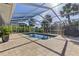 Screened-in pool area with spacious deck, tropical plants, and outdoor seating at 3415 Knox Ter, Port Charlotte, FL 33948