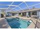 Screened-in pool with spacious deck, seating area, and access to the home's interior at 3415 Knox Ter, Port Charlotte, FL 33948