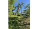 Two-story home with palms trees set amongst green foliage against a clear blue sky at 3601 Riverview Blvd, Bradenton, FL 34205