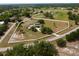 Aerial view of the estate featuring a horse property with sprawling pastures and mature trees at 3810 Hidden River Rd, Sarasota, FL 34240