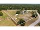Aerial view of the property featuring a home and expansive grassy lands at 3810 Hidden River Rd, Sarasota, FL 34240