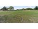 Large open field surrounded by trees and a wooden fence at 3810 Hidden River Rd, Sarasota, FL 34240