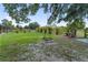 Large backyard with mature trees, a swing, and wood fence, offering plenty of outdoor space at 3810 Hidden River Rd, Sarasota, FL 34240