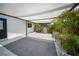 Inviting backyard space with a charming hot tub under a canopy, surrounded by lush greenery and decorative accents at 3810 Hidden River Rd, Sarasota, FL 34240