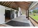 Barn with white walls, sliding doors, and a spacious covered walkway at 3810 Hidden River Rd, Sarasota, FL 34240