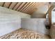 Interior of barn features concrete block walls, wooden beam ceiling, and sand covered floor at 3810 Hidden River Rd, Sarasota, FL 34240