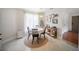 Dining room with round table, chairs, art and natural light at 3810 Hidden River Rd, Sarasota, FL 34240