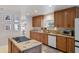 Granite counters, plentiful cabinets, and cooktop island highlight this spacious kitchen with exterior views at 3810 Hidden River Rd, Sarasota, FL 34240