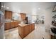 Spacious kitchen with granite countertops, a kitchen island with cooktop, and plenty of cabinet space at 3810 Hidden River Rd, Sarasota, FL 34240